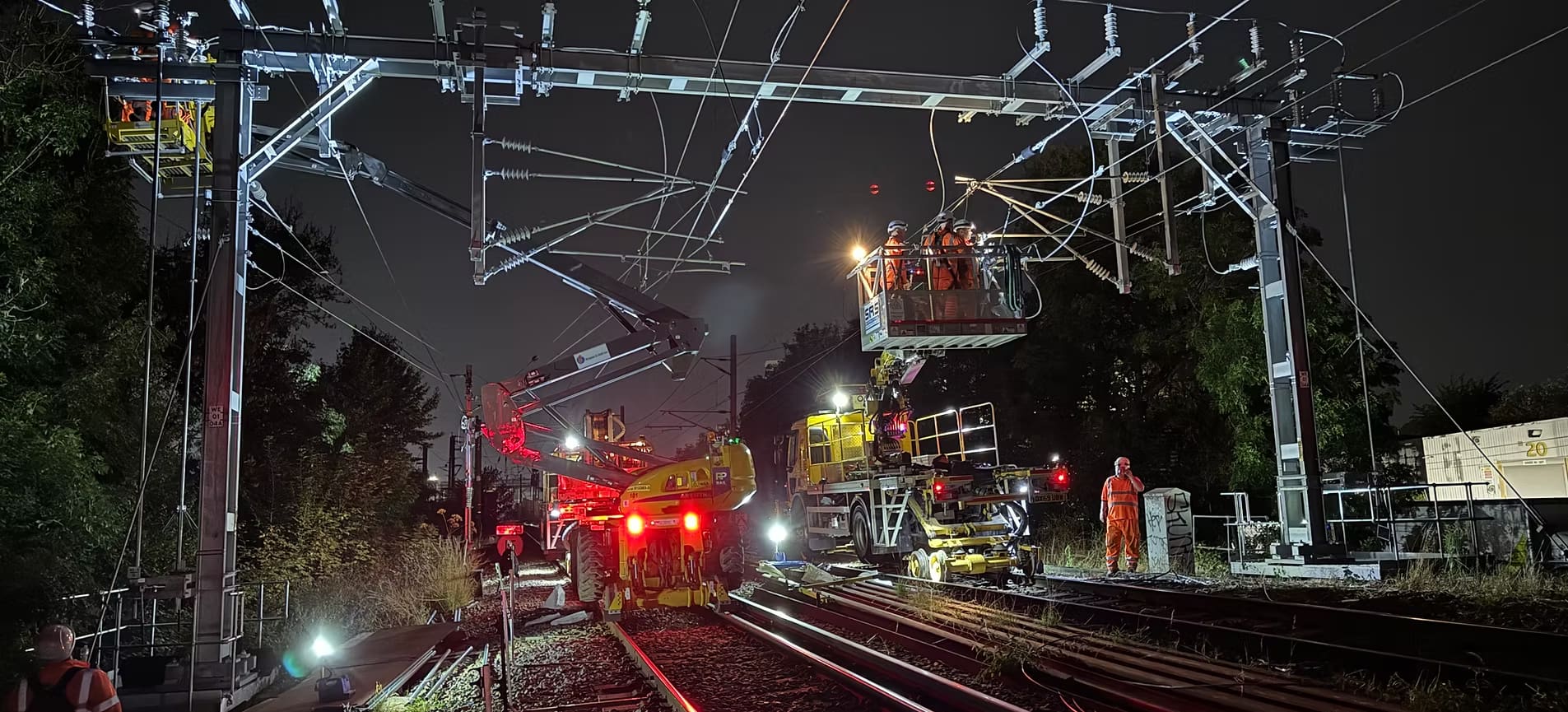 Overhead line engineers working on the UK rail network at night